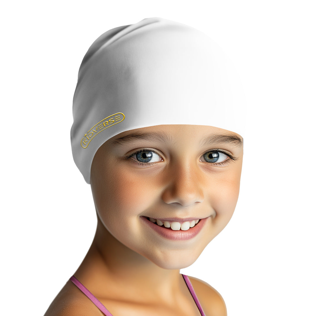 Kind lächelt fröhlich und trägt eine Kinderbadekappe in der Farbe Weiss